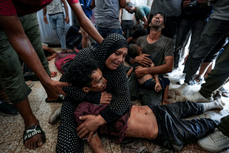 Faten Mreish holds her son's body at a hospital morgue in Deir al-Balah, Gaza Strip, Aug. 28, 2024, after he and others were killed in an Israeli bombardment.