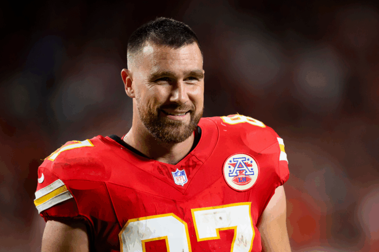Kansas City Chiefs tight end Travis Kelce smiles on the field.