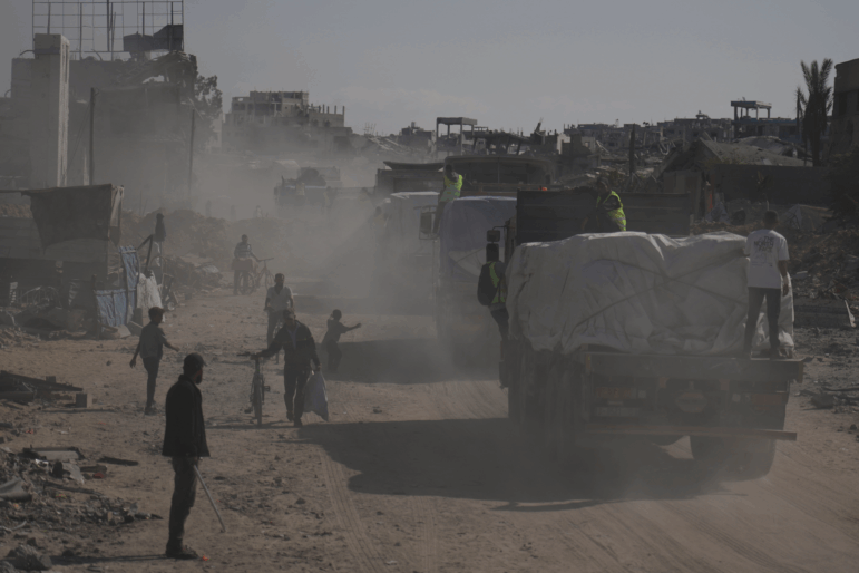 Trucks carrying aid from the United Nations' World Food Programme drive through Khan Younis, southern Gaza Strip, Sunday.