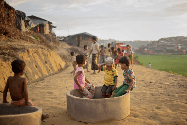 A group of children find a place to sit and play among the construction as Rohingya refugees build IDP camps outside of Cox's Bazar, Bangladesh on October 12, 2017.