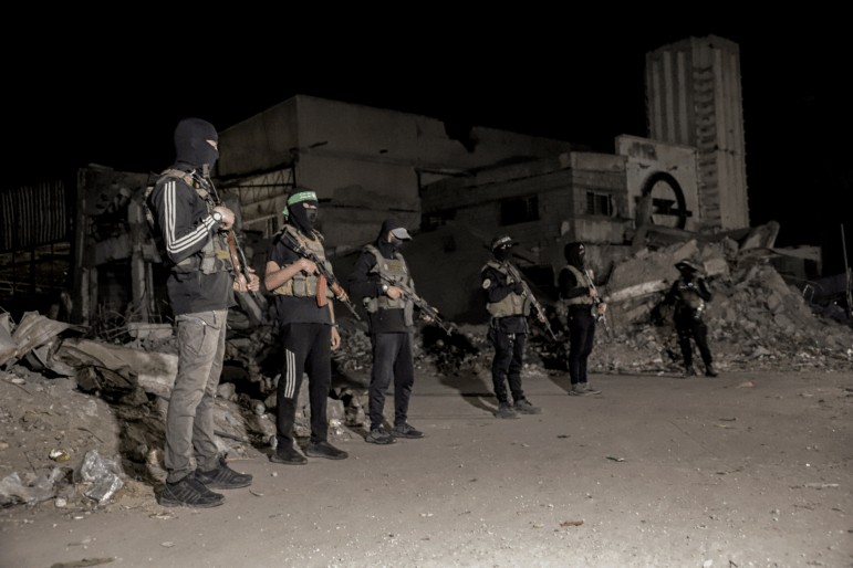 Hamas militants stand guard in Gaza City on Wednesday. Hamas police and other armed Hamas members have returned to the streets of Gaza since a ceasefire was announced last week. The plan calls for newly trained police to take over in Gaza, but it's not clear when that might happen.