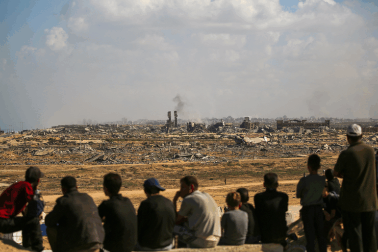 Palestinians look toward Gaza City from Nuseirat in the central Gaza Strip on Oct. 10, 2025. Gaza's civil defense agency said on October 10 that Israeli forces have begun pulling back from parts of the territory, particularly in Gaza City and Khan Yunis.