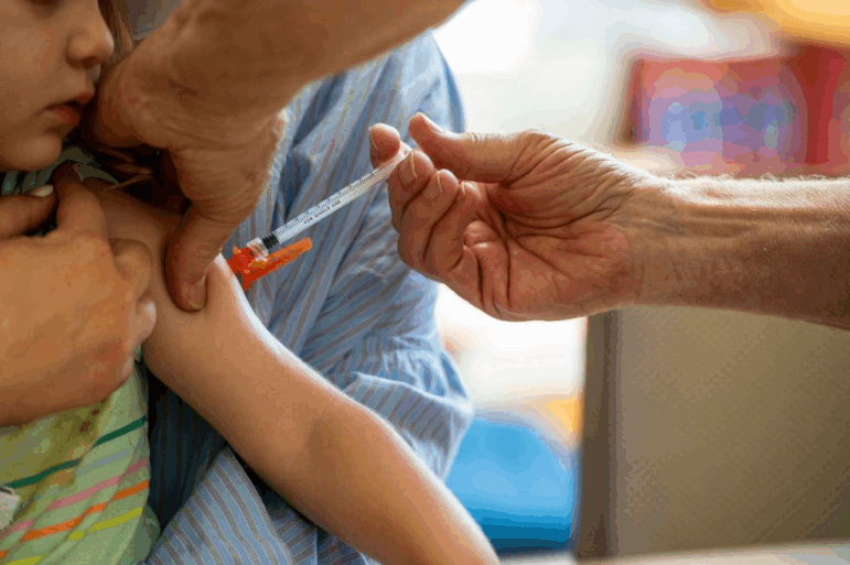 A young child receives a Moderna Covid-19 6 months to 5 years vaccination at Temple Beth Shalom in Needham, Massachusetts on June 21, 2022. The temple was one of the first sites in the state to offer vaccinations to anyone in the public.. US health authorities on Saturday cleared the Pfizer and Moderna Covid-19 vaccines for children aged five and younger, in a move President Joe Biden greeted as a "monumental step" in the fight against the virus. (Photo by Joseph Prezioso / AFP) (Photo by JOSEPH PREZIOSO/AFP via Getty Images)