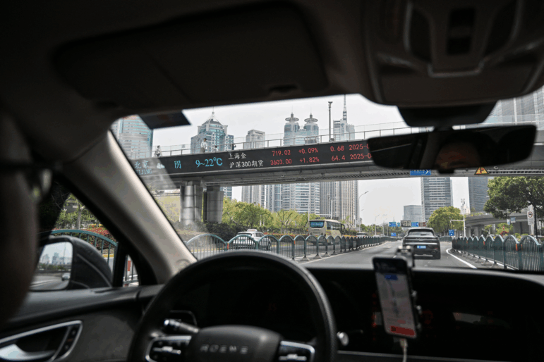 A DiDi ride-hailing driver travels through the financial district in Shanghai on April 9.