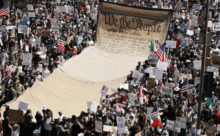 Protesters carry a large, long banner displaying the preamble to the U.S. Constitution in downtown Los Angeles during an anti-Trump No Kings Day demonstration on June 14.