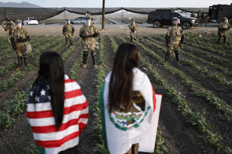 National Guard soldiers block protestors during an ICE immigration raid at a nearby cannabis farm on July 10 near Camarillo, California.