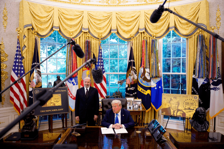 President Trump, accompanied by U.S. Commerce Secretary Howard Lutnick, speaks on Sept. 19 after signing an executive order in the Oval Office at the White House. Trump signed two executive orders, establishing the "Trump Gold Card" and introducing a $100,000 fee for H-1B visas.