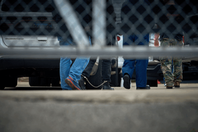 People detained by federal agents walk into a suburban Chicago ICE Detention Center in Broadview, IL on Sept. 19.