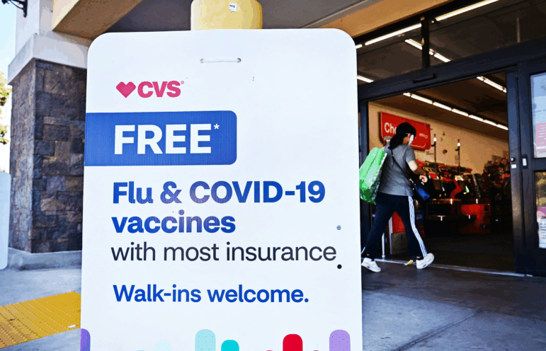 A person enters a CVS store in Monterey Park, California,  where flu and COVID-19 vaccines are offered.