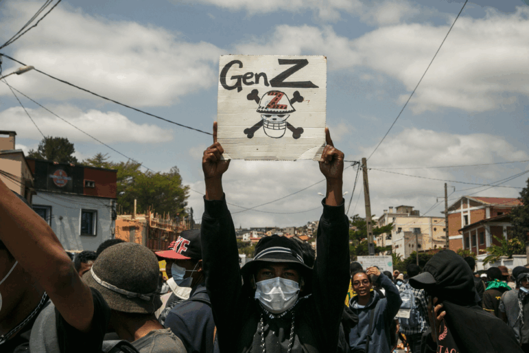 A protester holds a placard during a demonstration against repeated water and electricity outages in Madagascar.