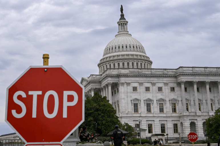 A stop sign stands in front of the U.S. Capitol in Washington, D.C.