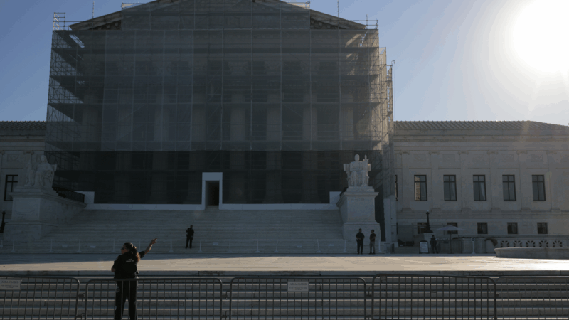 U.S. Supreme Court Police direct visitors from behind security barriers in front of court building, which is obscured in construction scaffolding, on the first day of the Court’s new term on Oct. 6 in Washington, D.C.