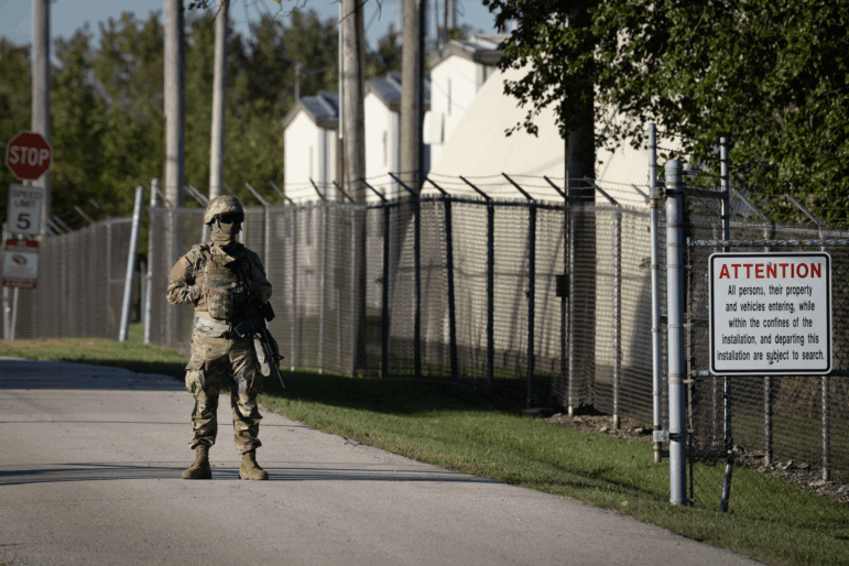 A member of the Texas National Guard stands at an army reserve training facility on October 07, 2025 in Elwood, Illinois.