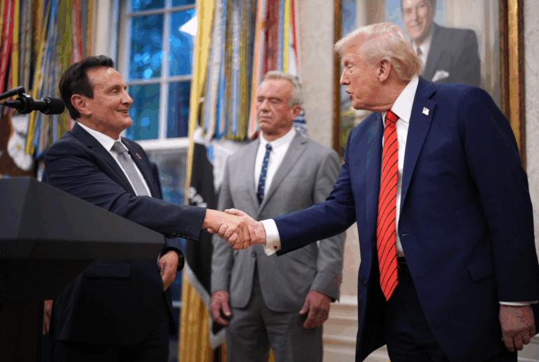 AstraZeneca CEO Pascal Soriot shakes hands with President Trump in the Oval Office, as Health and Human Services Secretary Robert F. Kennedy Jr. looks on. The president said Friday that AstraZeneca is the second drugmaker to reach a deal with the administration to lower U.S. prescription drug prices.