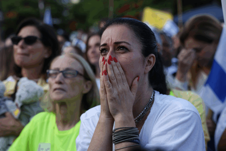 Israelis react as they wait for the release of Israelis still held in Gaza at Hostage Square in Tel Aviv early on Oct. 13, 2025.