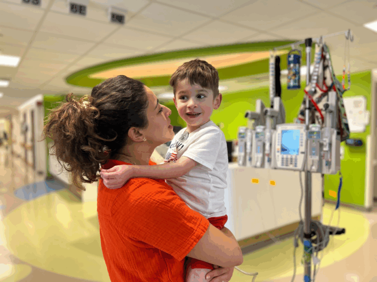 Caleb Strickland, age 4, is being carried in the arms of his mother, Nora Strickland.