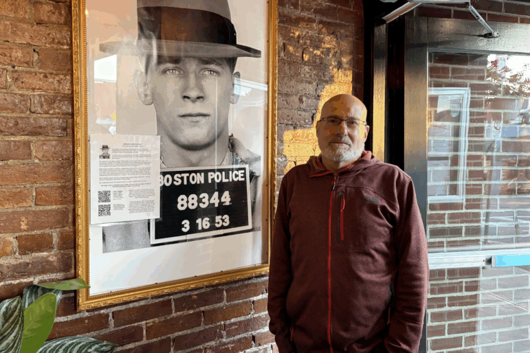 The photo of Boston Mobster James Whitey Bulger looms large over Kenneth Osherow, co-owner of the Savin Bar + Kitchen in Boston. Osherow hung a page of “context” on the photo, explaining it was not meant to “celebrate” the mobster, but to “acknowledge a chapter in the gritty, complex history of the neighborhood.”