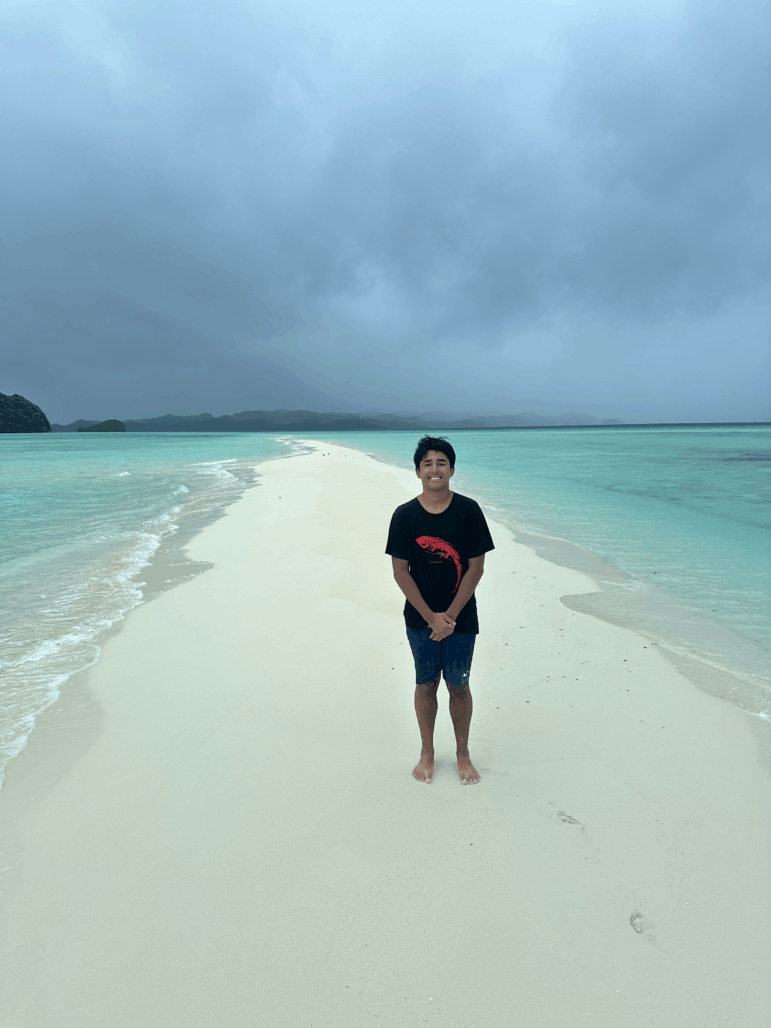 Arjun Malaviya stands on a sandbank in Papua New Guinea. He told NPR that he’s the youngest solo traveler to visit 100 countries. “I was 17 years and 228 days old when I reached my 100th country,” he said.