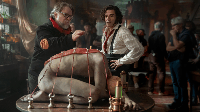 Director Guillermo del Toro, left, speaks with and Oscar Isaac on the set of Frankenstein.