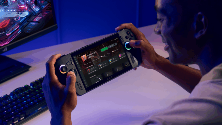 A promotional image for the ROG Xbox Ally X, demonstrating the handheld PC with a full gaming desktop nearby.