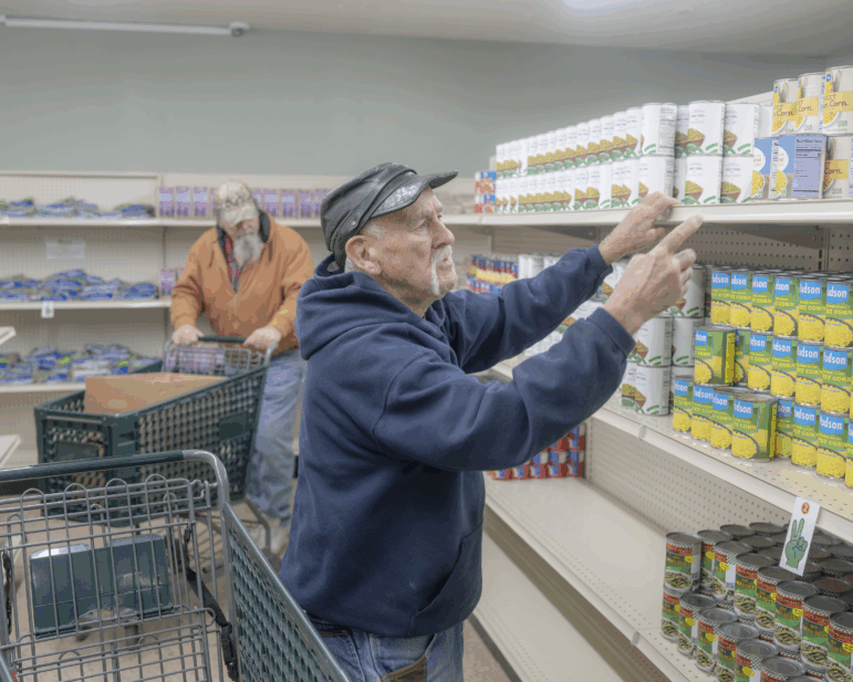 Paul B. Miller of Junction City, Ohio grocery shops at The Market in Logan, Ohio, on Dec. 9. Food aid was just one of many safety-net services offered here that faced disruption in 2025.