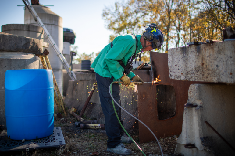 Grant Light demonstrates how to use a torch to cut through steel.