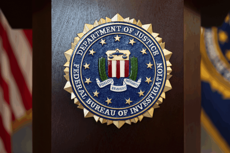 FILE - An FBI seal is displayed on a podium before a news conference at the field office in Portland, Ore., Jan. 16.