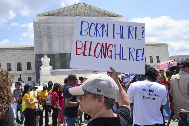 Jenny Harris, of Baltimore, protests in support of birthright citizenship and the immigrant community, May 15, 2025, outside of the Supreme Court in Washington.
