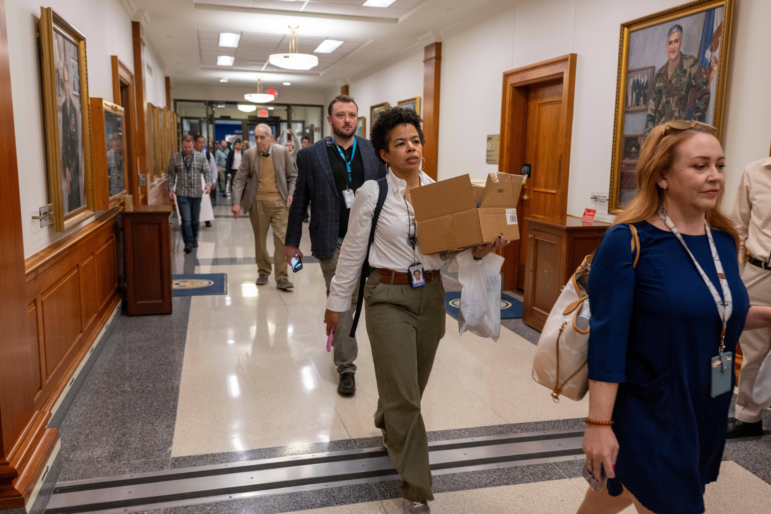 Members of the Pentagon press corps walk out of the Pentagon as a group after turning in their press credentials on Oct. 15.