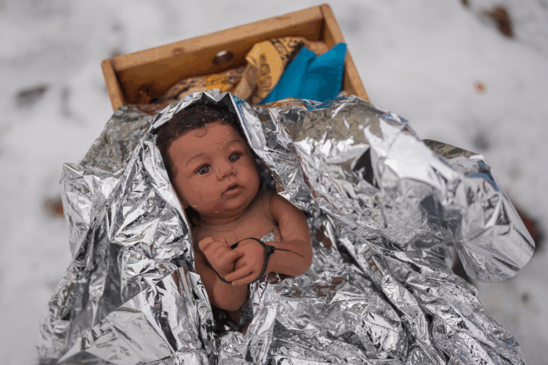 A doll representing the baby Jesus is zip-tied in the Nativity scene outside of Lake Street Church of Evanston, on Wednesday in Evanston, Ill. (AP Photo/Erin Hooley)