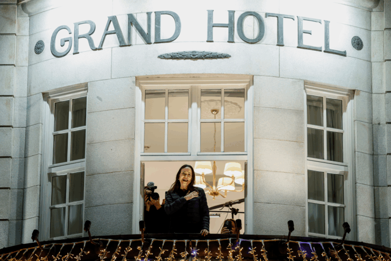 Nobel Peace Prize laureate Maria Corina Machado reacts to the crowd gathered below from a balcony at the Grand Hotel, in Oslo, Norway, early Thursday.