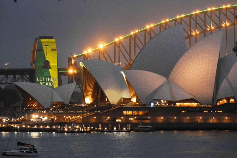 The social media ban for children under 16 slogan "Let Them Be Kids" is projected onto the pylons of the Sydney Harbour Bridge in Sydney, Wednesday, Dec. 10, 2025