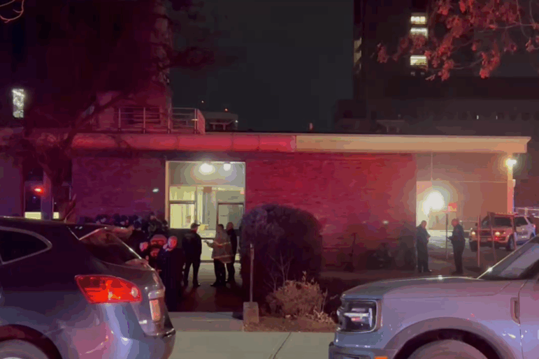 In this image from video, law enforcement officials gather outside the Brown University campus in Providence, R.I., on Saturday, Dec. 13, 2025.