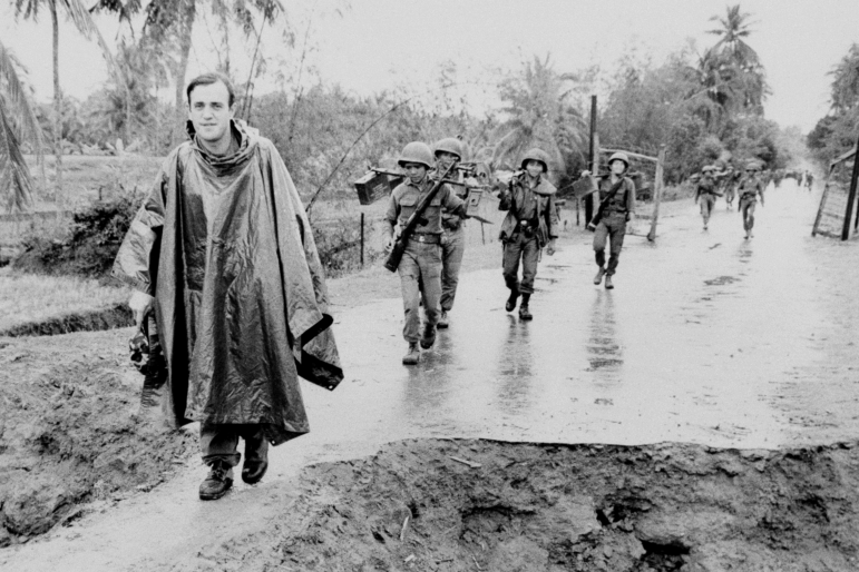 Associated Press correspondent Peter Arnett, left, marches with Vietnamese troops in Vietnam, Nov. 11, 1965.