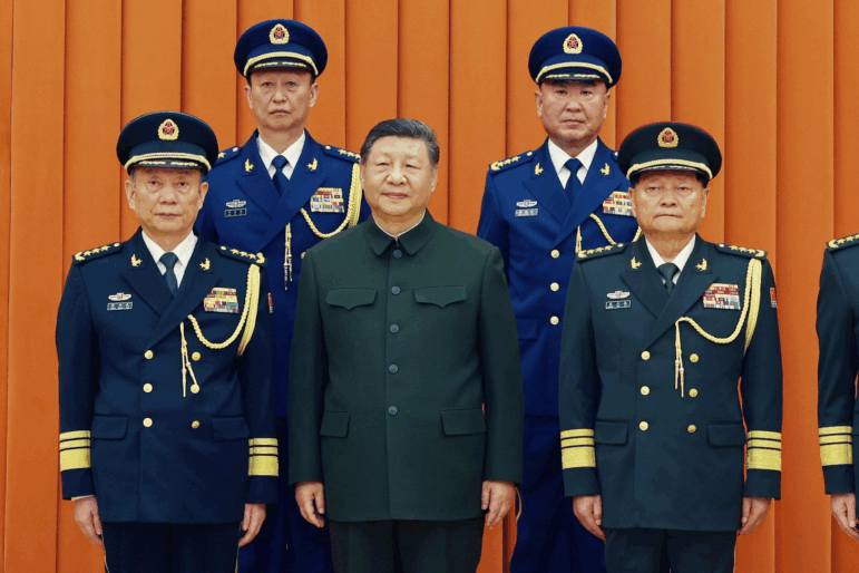 In this photo released by Xinhua News Agency, Chinese President Xi Jinping, also chairman of the Central Military Commission (CMC), front row second from left, poses with other military officers after promoting to generals, back row, from left, Yang Zhibin of the Eastern Theater Command and Han Shengyan commander of Central Theater Command in Beijing on Monday, Dec. 22, 2025.