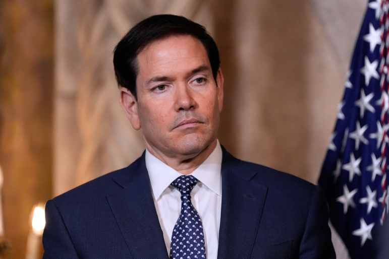 Secretary of State Marco Rubio listens as President Donald Trump speaks at his Mar-a-Lago club, Monday, Dec. 22, 2025, in Palm Beach, Fla.