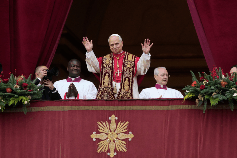 Pope Leo XIV waves Thursday after delivering the Urbi et Orbi (Latin for 'to the city and to the world' ) Christmas blessing from the main balcony of St. Peter's Basilica at the Vatican.