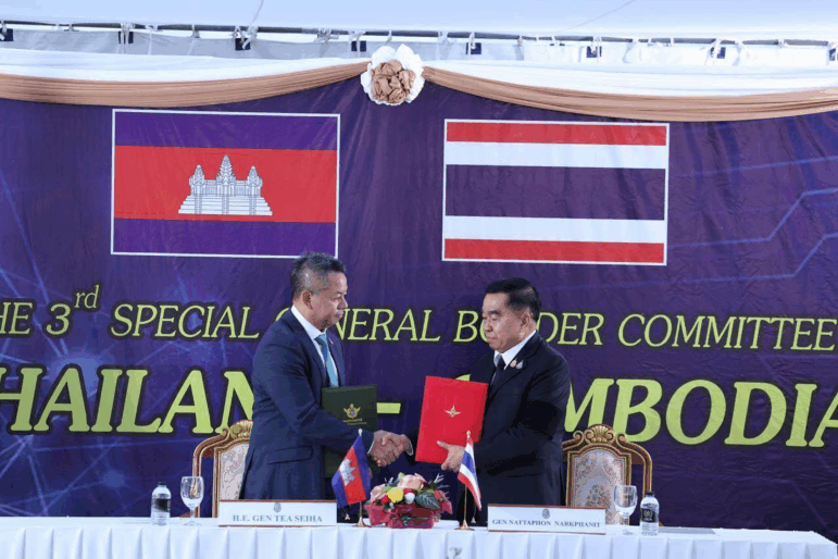 In this photo released by Agence Kampuchea Press (AKP), Cambodian Defense Minister Tea Seiha, left, stands with Thai Defense Minister Natthaphon Narkphanit, right, at the General Border Committee Meeting in Chanthaburi Province, Thailand Saturday, Dec. 27, 2025.