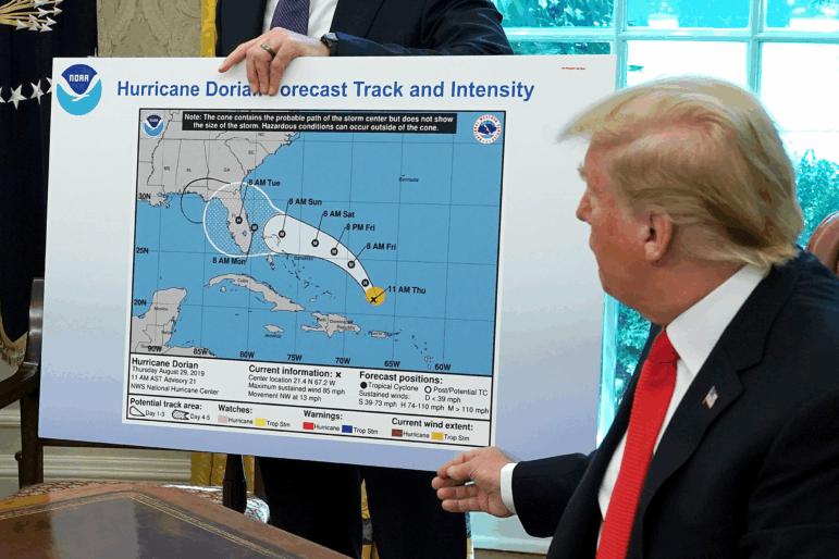 President Trump references a map while talking to reporters about Hurricane Dorian on Sept. 4, 2019. The map appears to have been altered by a black marker to extend the hurricane's range to include Alabama.