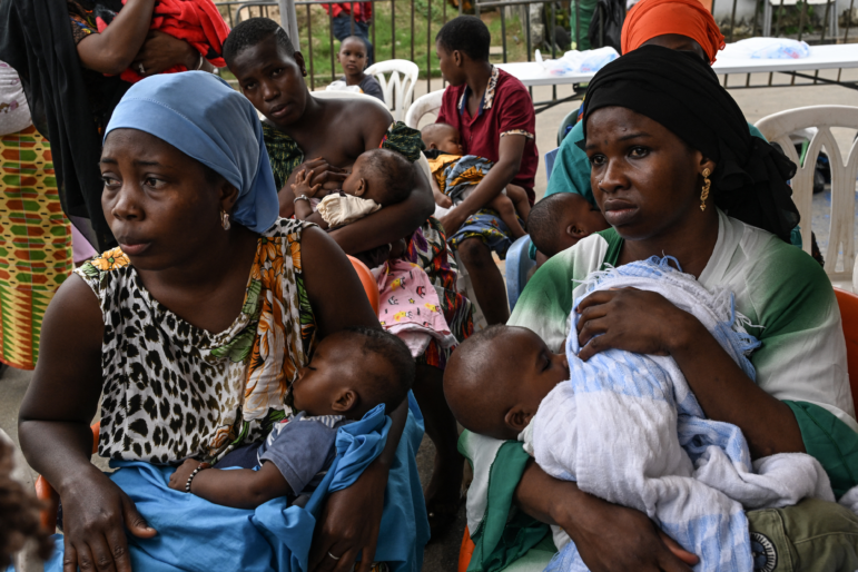 Women breastfeed their babies while waiting to have them vaccinated against malaria during the launch of the vaccination campaign for children from zero to 23 months at La Marie d'Abobo, a popular commune in Abidjan on July 15, 2024. In Abobo, a working-class district of Abidjan, dozens of women line up in front of nurses, babies strapped to their backs in a loincloth: Ivory Coast has launched its first vaccination campaign against malaria, which mainly kills children under 5 years old.