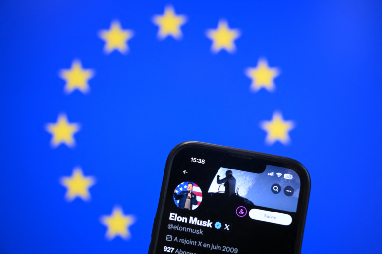 This illustration photograph shows Elon Musk's X (formerly Twitter) account displayed on a smartphone in front a European Union flag.