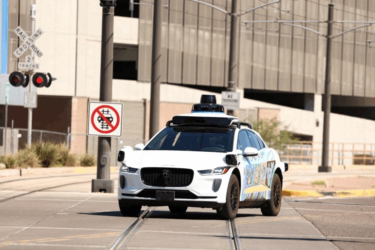 A Waymo autonomous Jaguar electric vehicle is seen in Tempe, Ariz., on the outskirts of Phoenix, on Sept. 15.
