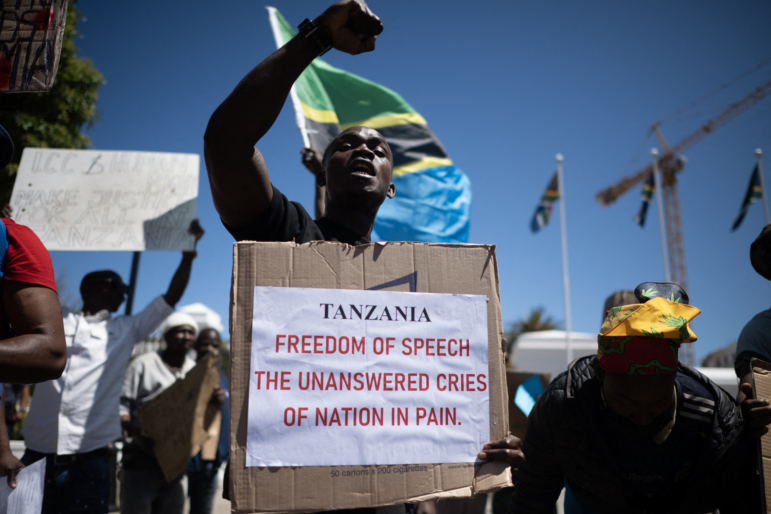 A protester holds a placard during a picket in Cape Town, South Africa, protesting against the Tanzanian government during their presidential election in Oct. 2025