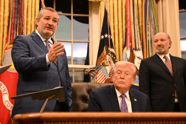 President Trump, center, and Secretary of Commerce Howard Lutnick, right, listen as U.S. Sen Ted Cruz, R-Tex. speaks during a signing ceremony for an executive order on AI at the White House on Dec. 11, 2025.