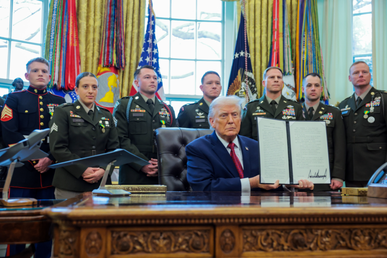 President Donald Trump poses with a recently signed executive order classifying fentanyl as a "weapon of mass destruction," during a ceremony in the Oval Office of the White House on Dec. 15.