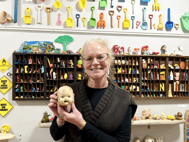 Corinn Flaherty holds the first doll head she found washed ashore in 2015. It propelled her "descent down the flotsam rabbit hole" and was her inspiration for the Plum Island Museum of Lost Toys & Curiosities.