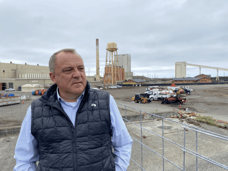 Chris Mikkelsen, executive director of the Humboldt Bay Harbor District, stands on the site of a planned marine terminal in Eureka, Calif. that will assemble wind turbines. The Trump administration recently canceled more than $426 million in federal grants for the port.