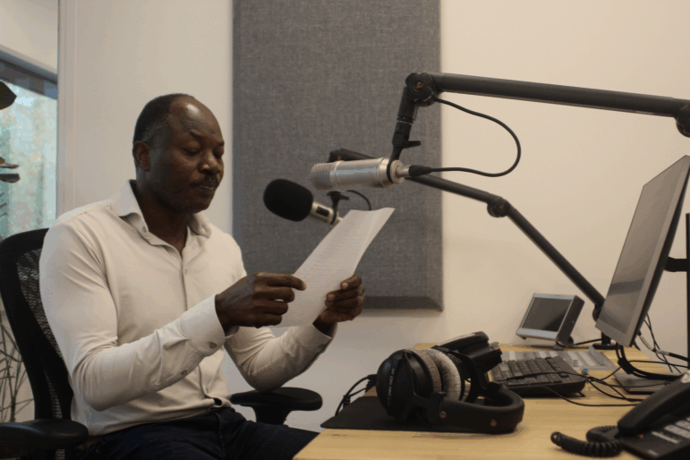 Reporter Elamin Babow reads the latest headlines in Radio Dabanga's office in Amsterdam on Oct. 16. The station is a lifeline for Sudanese people trying to get information about their war-torn country.