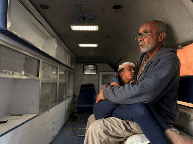 Saqer al-Ankah holds his 10-year-old granddaughter, Bayan al-Ankah, after he says she was shot in the head by Israeli forces in northern Gaza about half a mile from the so-called yellow line on Dec. 10.