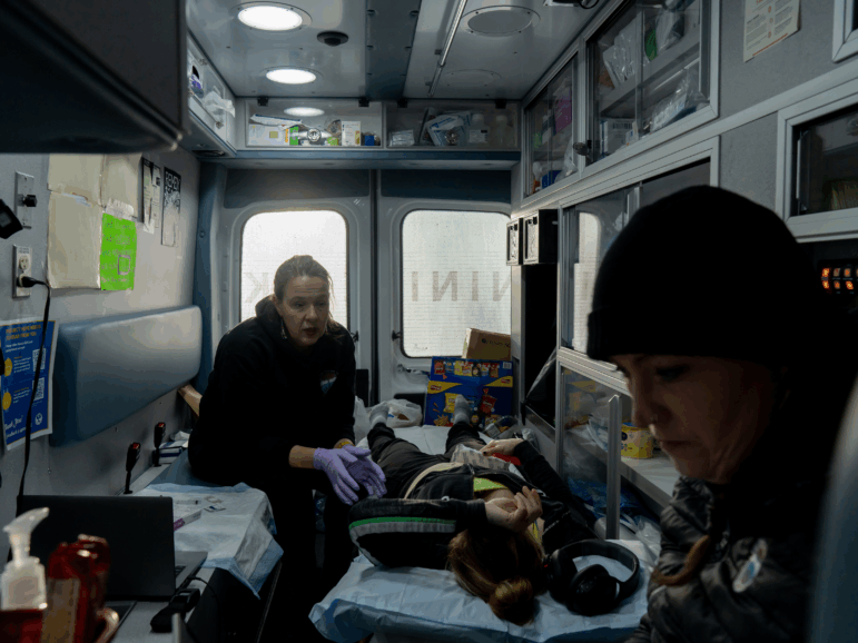 Dr. Sarah Spencer and Case Manager Annette Hubbard see a patient in the mobile clinic outside of a shelter in Kenai, Alaska on November 20, 2025.